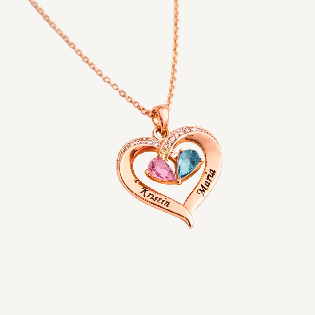 Rose gold heart-shaped necklace with two names engraved and two birthstones on a white background