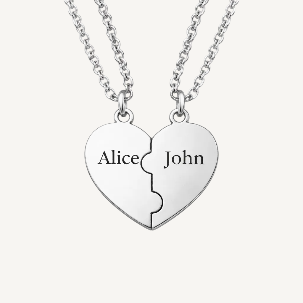 Silver heart-shaped pendant with 'Alice' and 'John' engraved on a beige background