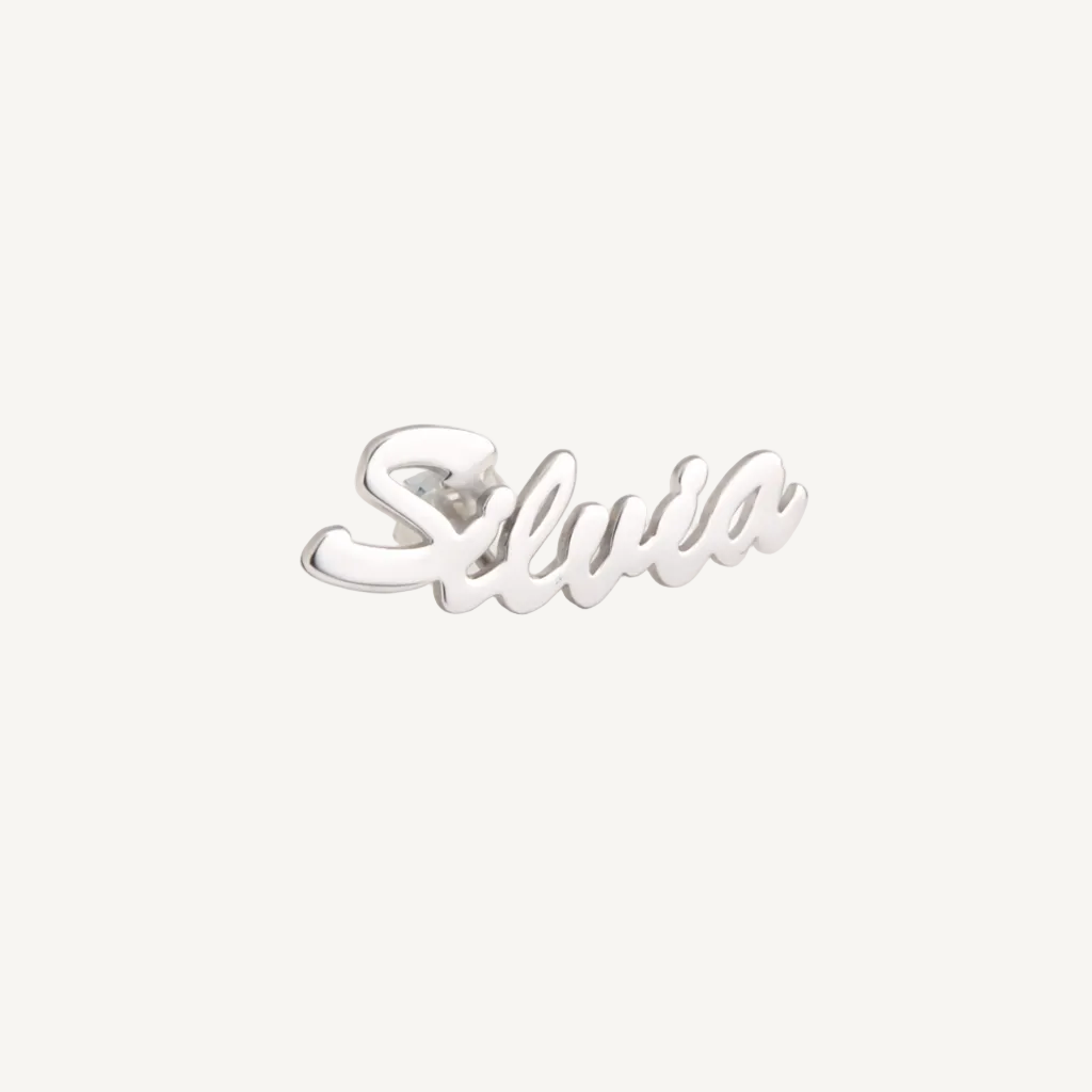 Silver 'Silvia' earring on a beige background