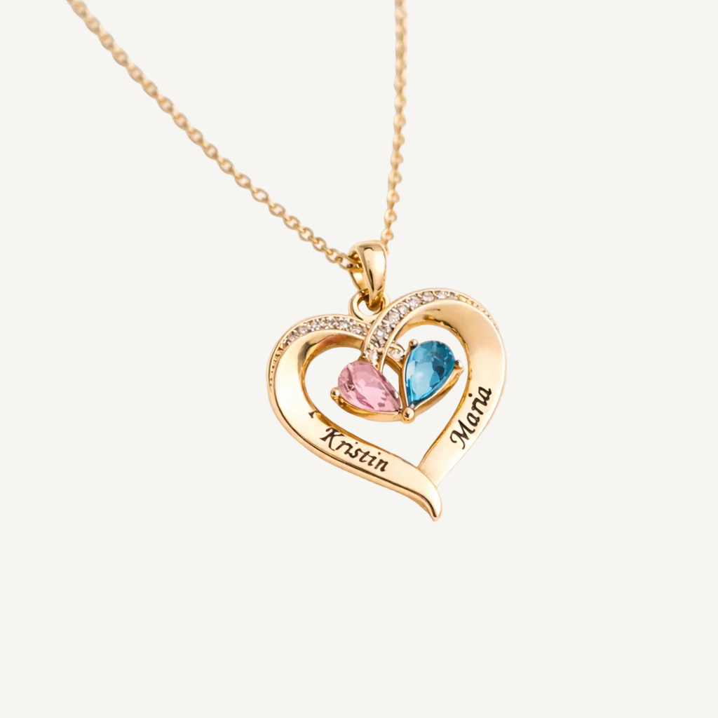 Gold heart-shaped necklace with two names engraved and two birthstones on a white background