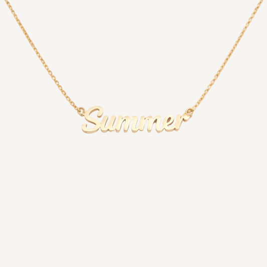 Gold necklace with 'Summer' pendant on a white background